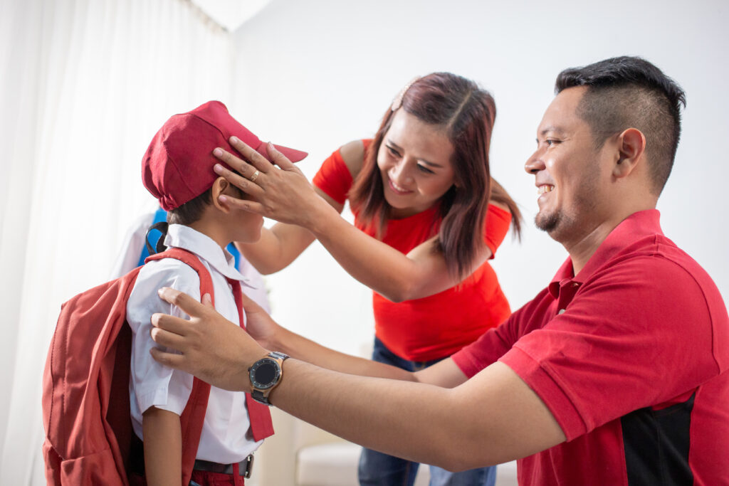 An image of parents happily preparing their child for a session at their chosen primary math tuition in Singapore