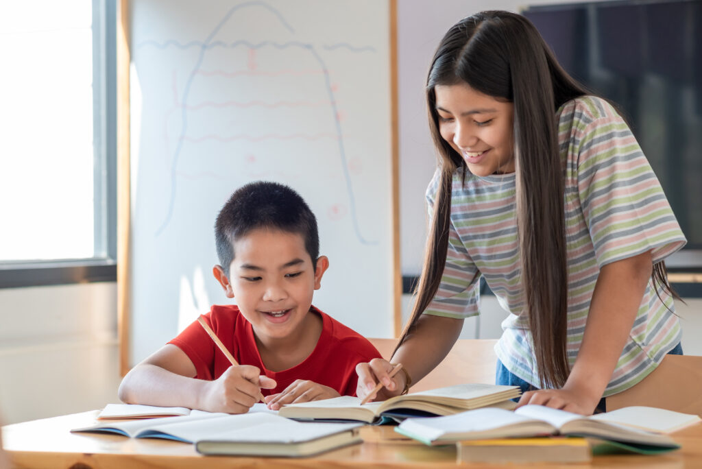 Primary school students practising how to solve PSLE problem sums through guided learning, heuristic strategies, and structured mathematical thinking.