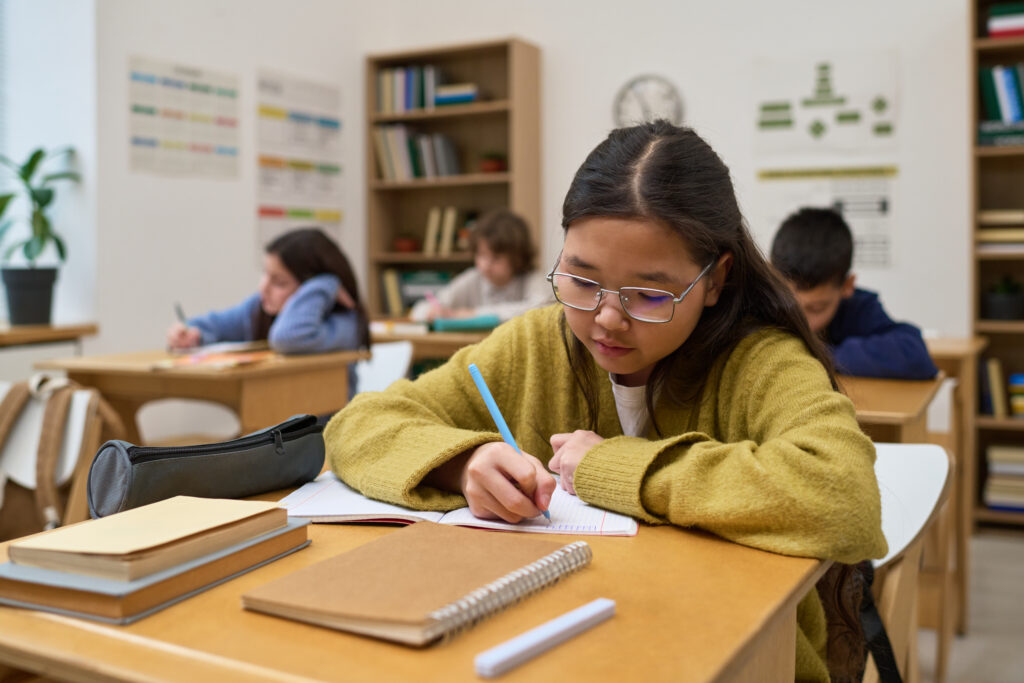 Student applying PSLE Math Tips during classroom practice to strengthen problem-solving accuracy, logical reasoning, and examination confidence.