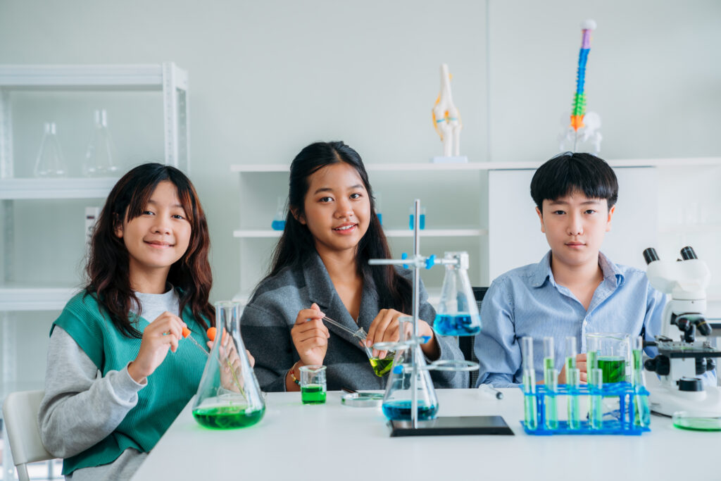 Students using an O Level Chemistry Study Guide during laboratory learning to strengthen scientific reasoning, concept application, and exam preparation skills.