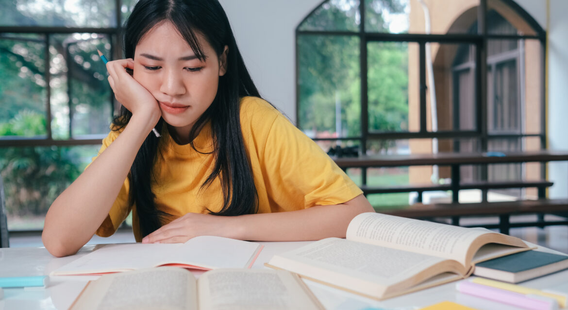 A frustrated P6 student making the common PSLE math mistakes in her workings